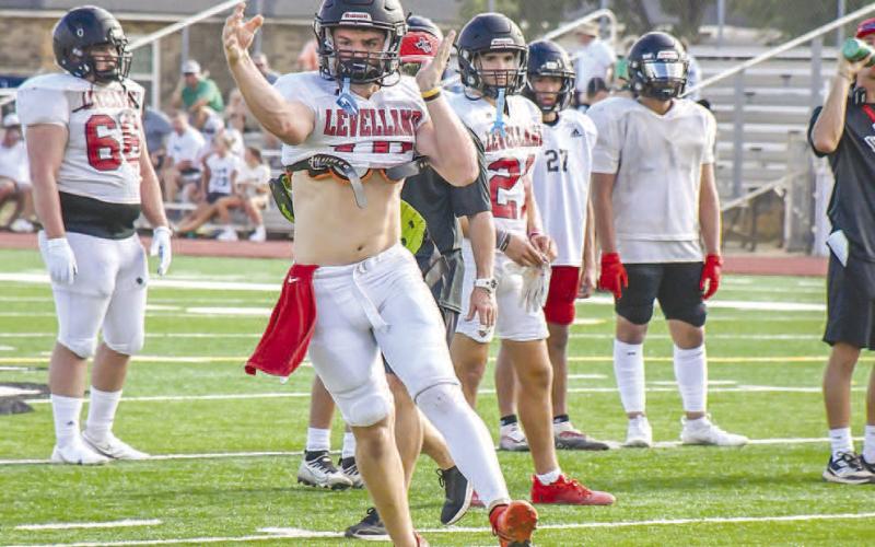 THROW ON THE RUN - Levelland quarterback Rusty Johnson threw the ball to his recievers during Levelland’s scrimmage against Idalou this past Friday night. (Staff photo by Dom Puente)