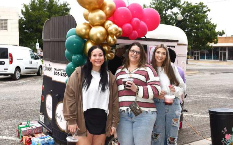 YUMMY DRINKS - Pictured are Clarissa Holland, Erica Soliz and Abi Soliz in front of the Smokin D’s trailer outside of Studio K on Saturday during the Rise, Shine and Shop event in Downtown Levelland. During the event, shoppers were treated to complementary brunch while perusing various participating shops. (Staff photo by Ada Niederhauser)