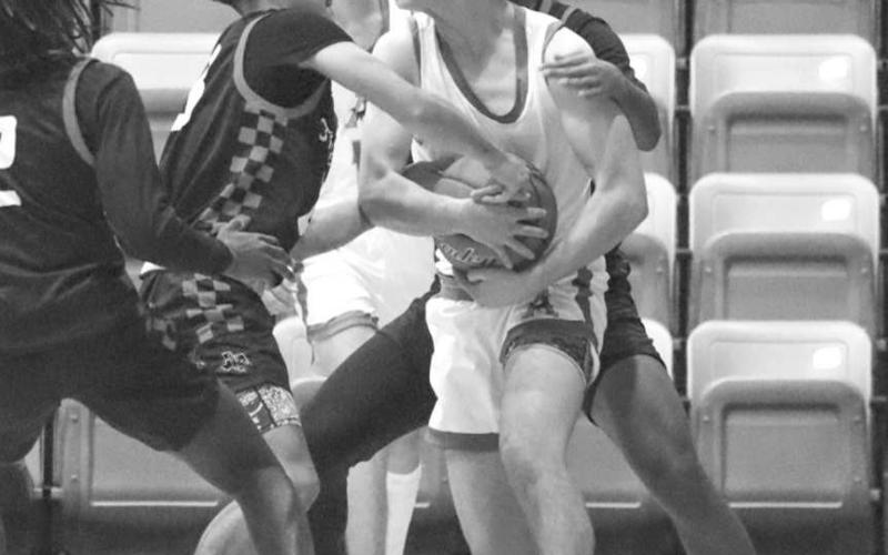 JUMP BALL - Levelland Lobos Sean Landrum and Ozzie Salano forced a turnover against the Andrew Mustangs last Tuesday night in the teams loss as the away team. (Staff photo by Aalijah Soliz)