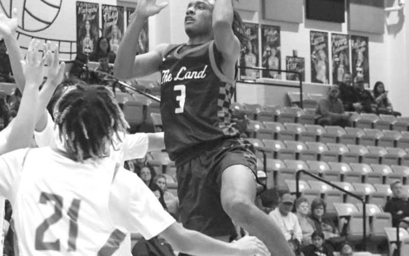 TOO TALL - Levelland Lobo Eryk Jones shot the ball over the defense to get the Lobos some much needed points in the teams one point loss against the Andrews mustangs. (Staff photo by Aalijah Soliz)