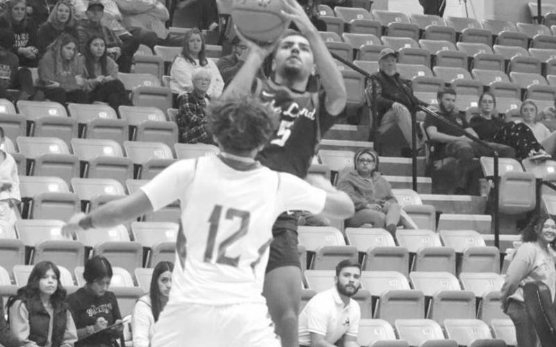 HIGH SHOT - Levelland Lobo Sean Landrum shot the ball over the Andrews defender to get the team easy points in their close game last Tuesday. (Staff photo by Aalijah Soliz)