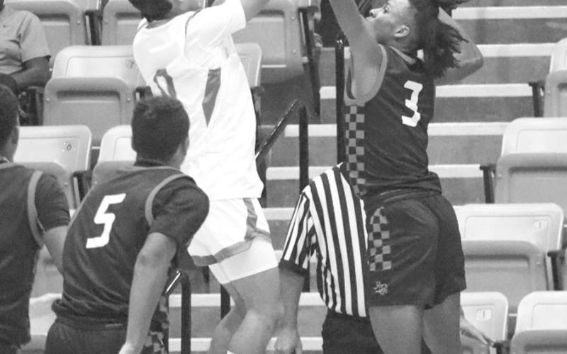 NO EASY SHOTS - Levelland Lobo Eryk Jones went vertical to block the shot from the Mustang athlete last Tuesday in the teams away game loss. The Lobos competed in the Denver City Tournament this weekend to test their skills. (Staff photo by Aalijah Soliz)