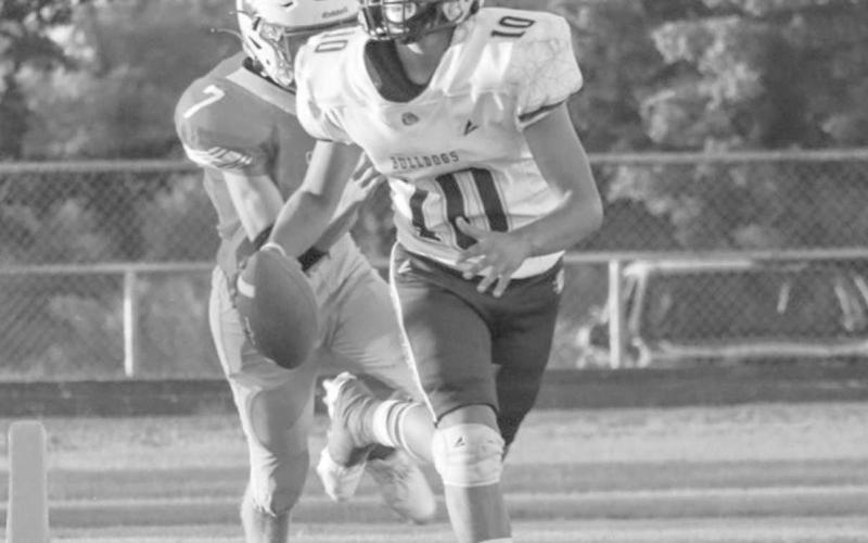 ON THE RUN - Anton Bulldog Gavin Martinez ran out of the pocket while looking downfield for the pass last Thursday against the Eagles in Motley County. (Staff photo by Aalijah Soliz)