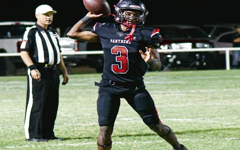 THROW ON THE RUN - Whitharral senior Brent Robinson makes a throw on the run during their Homecoming game against the Valley Patriots at McCormack-Doshier Field this past Friday night. Robinson would throw for two touchdowns on the night and add another one rushing as well in the Panthers 68-48 win. (Staff photo by Jentezen Smith)