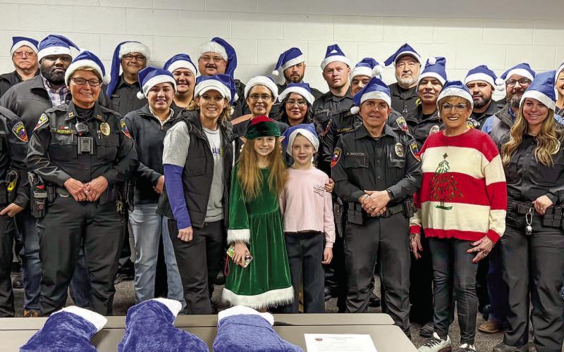 BLUE SANTA - The Blue and You non-profit organization held their annual Blue Santa event on Dec. 14. Pictured are Blue and You volunteers along with local law enforcement. The winter-time activity allows for sponsored local children to be picked up by the Levelland Police Department (LPD) for breakfast and a visit to Walmart for shopping. (Staff photo by Essence Childers)