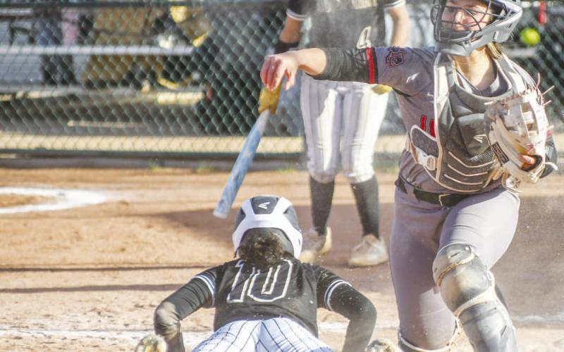 LOCKDOWN DEFENSE - With runners on second and third for the Big Spring Lady Steers in the top of the fifth inning, Loboette catcher Madi Seat would attempt the pick at second promting the Lady Steer at third base to try and take home. Loboette second baseman Delany Delgado would get the ball back to Seat for the successful tag at home. Seat would try to follow up with a throw down to third as the runner at second would beat the tag by Loboette third baseman Mari Reyna. (Staff photo by Dom Puente)