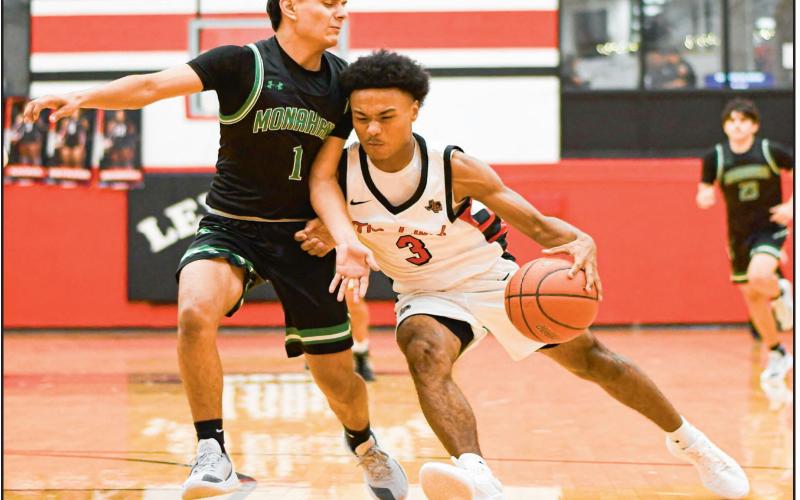 PLAYING THROUGH CONTACT - Levelland Lobos sophomore point guard Bryson Golightly plays through contact while driving to the basketball hoop during their home game against Monahans this past Tuesday night. Golightly would finish with eight points. (Staff photo by Jentezen Smith)