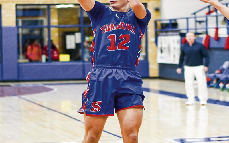 MID-RANGE GAME - Sundown Roughneck Rylan Carr steps into a mid-range jump shot and nails it during their district game against Smyer this past Friday night at Smyer High School. (Staff photo by Jentezen Smith)
