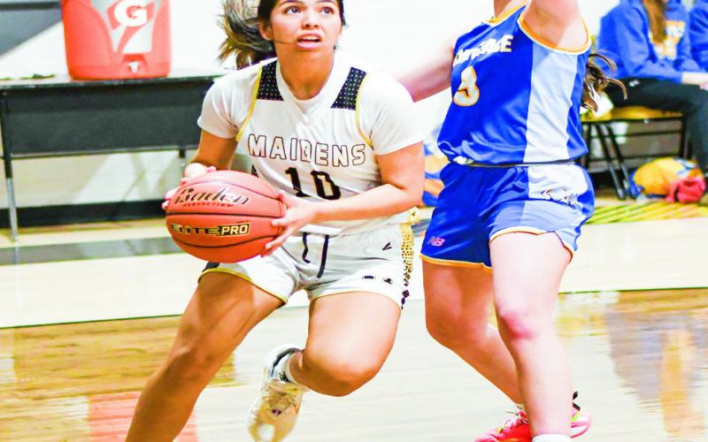 BASELINE BATTLE - Morton’s Khloe Aguirre drives on the baseline as Whiteface’s Kambry Sanders guards her during their district matchup this past Tuesday at Morton High School. (Staff photo by Jentezen Smith)