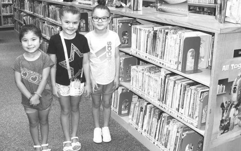 READING FUN- The Hockley County Library Program held their weekly reading program on Wednesday which themed “Bagels and Reading.” Pictured from right to left are: Parker Neill, Olivia Berry and Mia Serna who participated in reading, drawing, eating bagels and beating the heat by doing activities in the library. (Staff photo by Emily Campos)