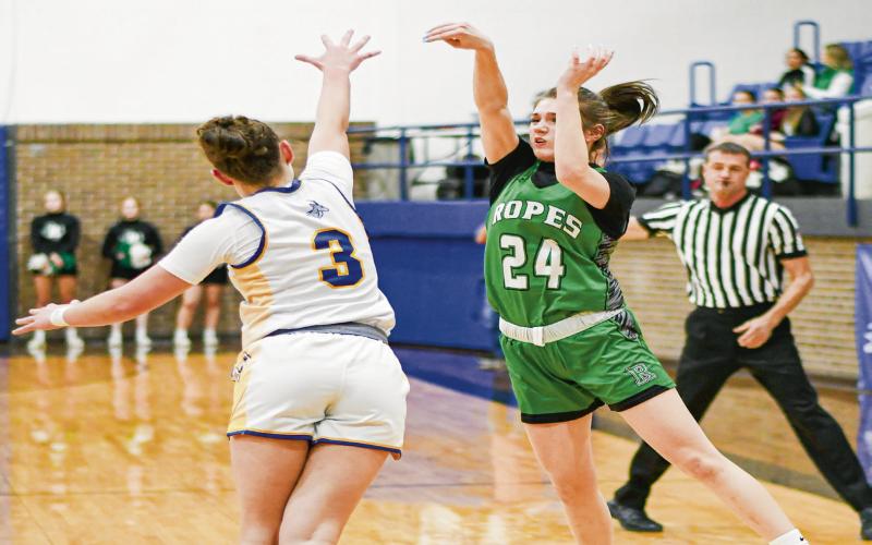 BUZZER BEATER ATTEMPT - Ropes Lady Eagle Rylie Lester shoots a three-pointer at the buzzer over the outstretched arms of Whiteface Lady Lope Kambry Sanders. Lester would be Ropes’ second leading scorer with nine points. (Staff photo by Jentezen Smith)