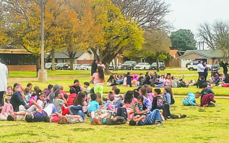 FUN IN THE SUN? OR SHADE? - Community members spent time outside captivated by the solar eclipse event that too place Monday afternoon. Students and faculty from Capital Elementary enjoyed their time outside observing the eclipse. (Photo courtesy of Emily Campos)