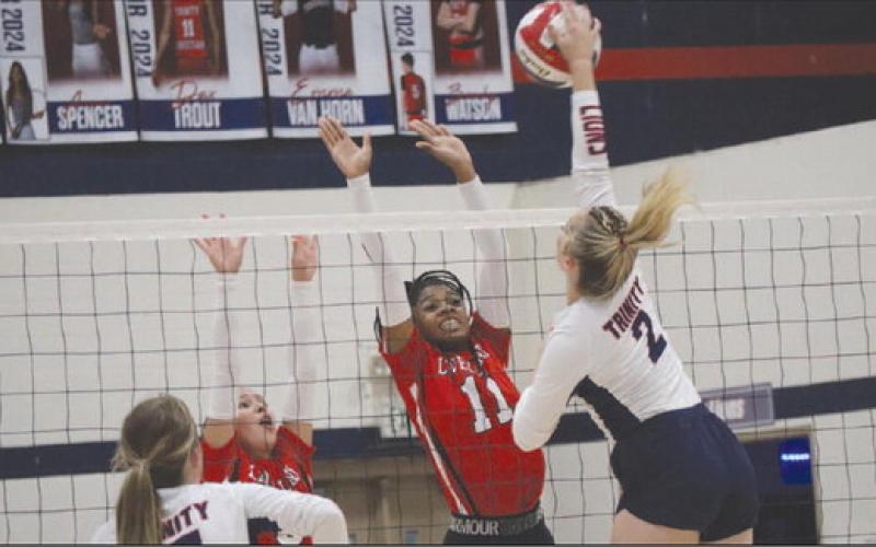 DEFENSE - Levelland athletes Tanaesia Brackens and Allison Monge made the great effort block on the Lady Lion this past Tuesday. The Loboettes finished their regular season with a record of 13-16 as they go into district play. (Staff photo by Aalijah Soliz)