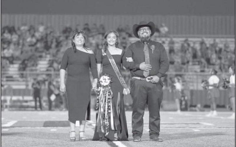 SENIOR COURT - Senior Alanis Valderas was escorted out by her parents Maria and Adam Valderas during last Friday’s homecoming. (Staff photo by Dom Puente)