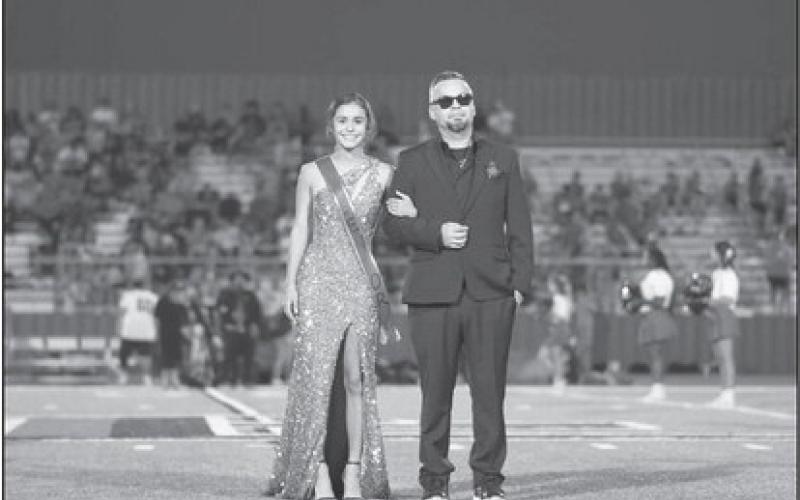 SENIOR COURT - Senior Carley Tienda ws escorted out on the field by Erik Tienda last Friday during homecoming at Lobo Stadium. (Staff photo by Dom Puente)