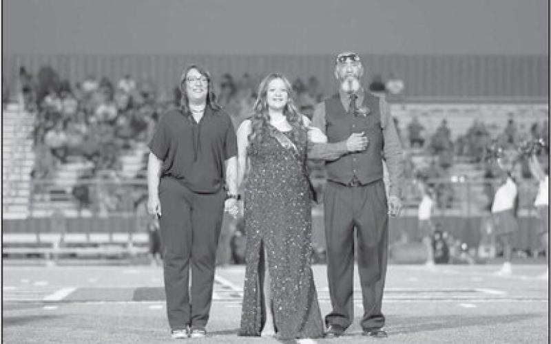 FRESHMAN COURT - Freshman Via Hernandez was escorted onto the field by her parents Angel and Vicky Hernandez during homecoming last Friday. (Staff photo by Dom Puente)