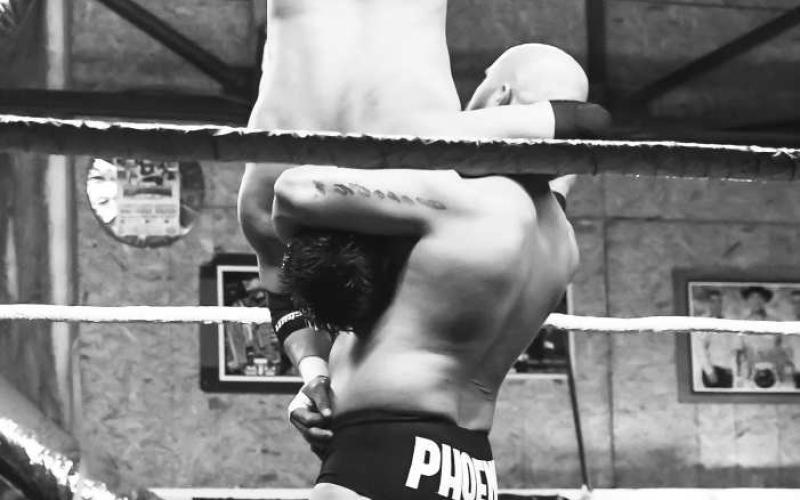 GOING FOR THE WIN - Emilio Guzman being lifted by Phoenix at the B.C.W. Pro Wrestling event at TMW Event Center Saturday. Guzman defeated Phoenix by pinning him down for three seconds. (Staff photo by Victoria Byrnes)