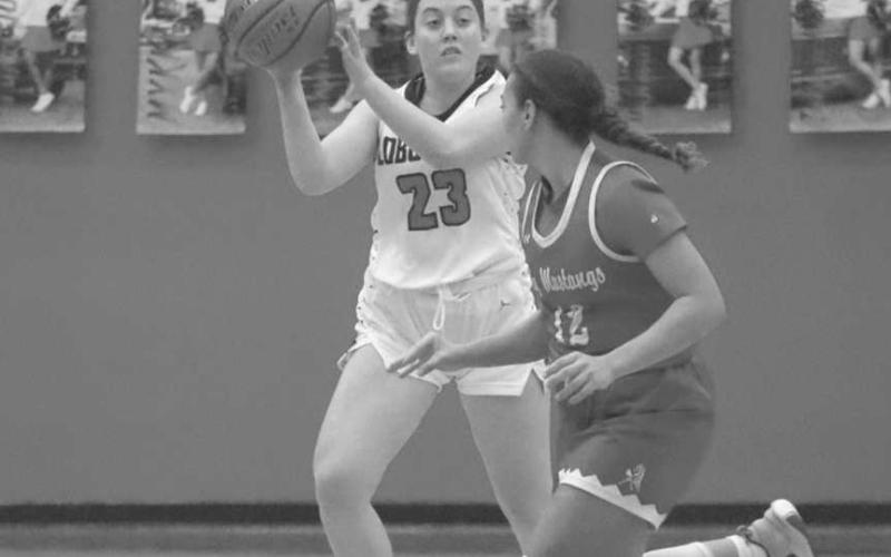 DOWNHILL - Levelland Loboette Maddie Stafford grabbed the rebound and threw a pass down the court during the teams win against the Sweetwater Lady Mustangs this past Tuesday. (Staff photo by Aalijah Soliz)