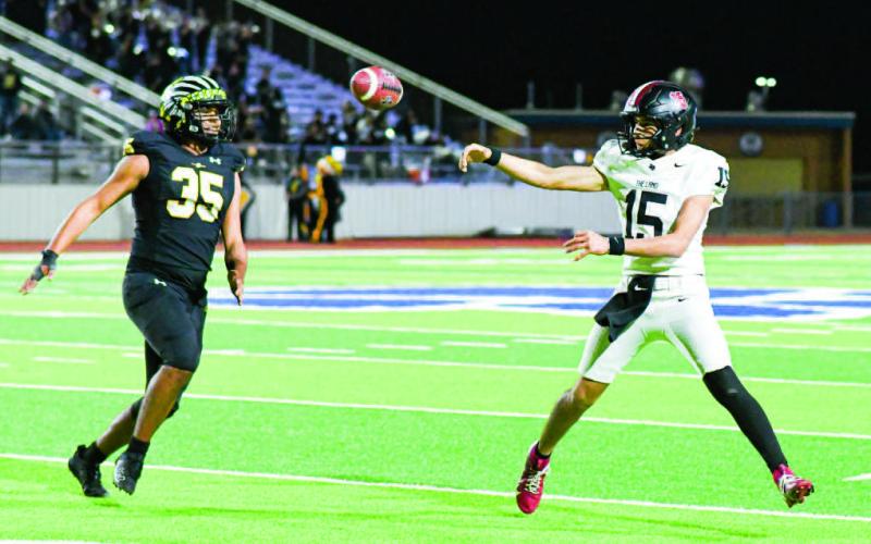PLAYOFF PERFORMER - Levelland junior starting quarterback Ethan Salazar makes a throw on the run from a Seminole defender during their playoff football game this past Friday at Frenship High School. Salazar would end with 291 yards of total offense and three touchdowns. See full story “Levelland falls to Seminole” on page 8 (Staff photo by Jentezen Smith)