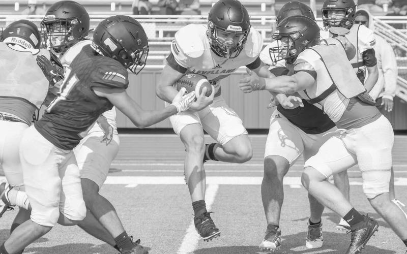 QUICK CUT - Levelland Lobo Jake Potter hit the hole that his offensive line made for him this past week during two-a-day practices at Lobo Stadium. (Staff photo by Dom Puente)