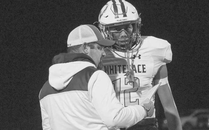 GAMEPLAN - Whiteface Antelope Isaak Soliz got the playcall from Head Football Coach Clint Linman this past Friday night against the Coyotes. (Staff photo by Aalijah Soliz)