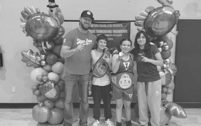SHARKATTACK - The Levelland Boxing Center “Shark Attack” boxing team competed Nov 9, in Amarillo. Jeremy “Caos” Philips won by unanimous decision. “Day Day” Salinas won by the third round by TKO. Pictured above are the coaches Tray Philips and April Olivas with their fighters. (Photo courtesy of Levelland Boxing Center)