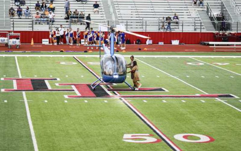 GAME-BALL DELIVERY – The Levelland Football game ball is delivered to Head Coach Lyle Leong by helicopter as it lands in the middle of the football field at Lobo Stadium this past Friday night. The Lobos would go on to win 41-21. (Staff Photo by Jentezen Smith)