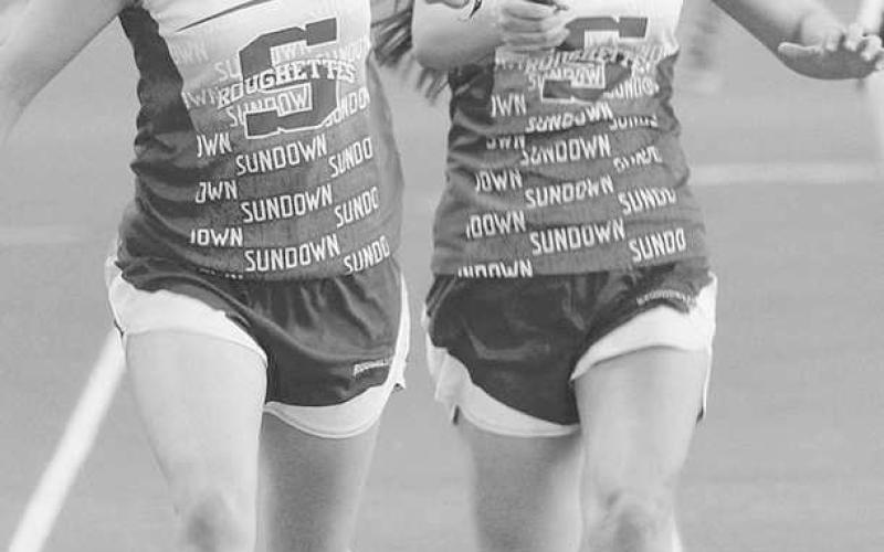 RELAY CHAMPS- The Sundown Roughette seventh and eighth grade track teams won district championships in track. The Roughneck seventh grade team placed fourth and the eighth team placed third. Roughette 200 relay runner Adelyn Franklin hands the baton to the anchor leg Kassady Rodgers. (Photo Courtesy of Sundown ISD)