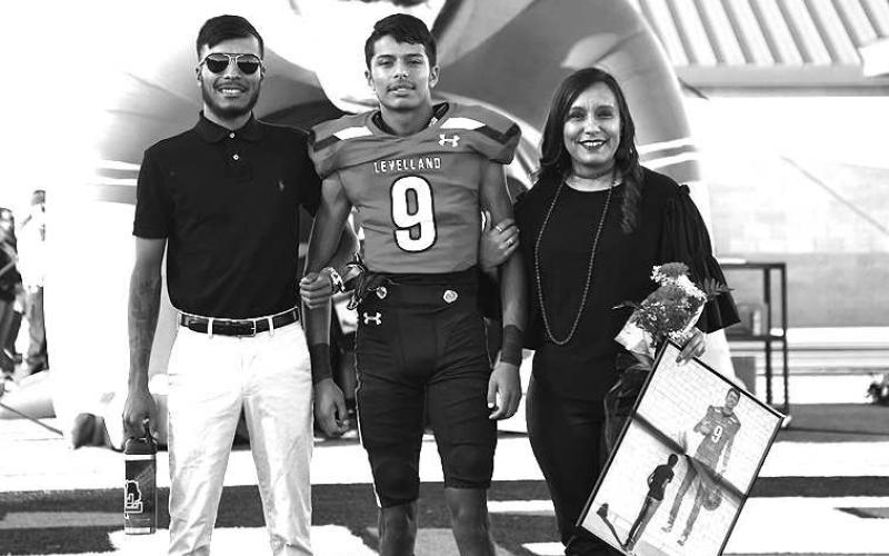 SENIORLOBO- Levelland seniors were recognized last Friday during the Lobos home win game against Borger. Lobo Matthew Bautista was escorted by his mother Annette Bautista and brother Zach Bautista. (Staff Photo by Dom Puente)