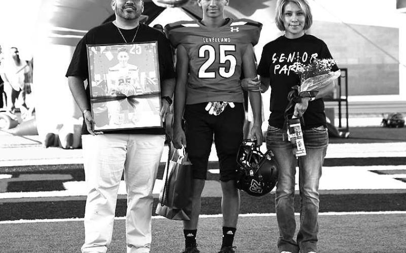 SENIORLOBO- Levelland seniors were recognized last Friday during the Lobos home win game against Borger. Lobo RJ Lopez was escorted by his parents Raul and Jessica Lecroy. (Staff Photo by Dom Puente)