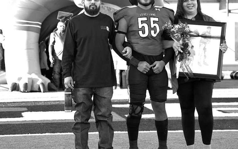 SENIOR LOBO- Levelland seniors were recognized last Friday during the Lobos home win game against Borger. Lobo Xavier Espinoza was escorted by his parents Aaron Cuellar and Caroline Espinoza. (Staff Photo by Dom Puente)