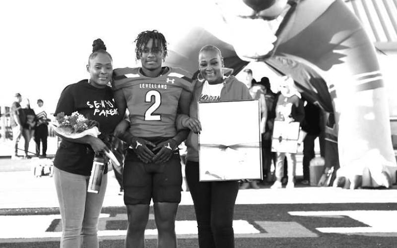 SENIOR LOBO- Levelland seniors were recognized last Friday during the Lobos home win game against Borger. Lobo Ladarian Jordan was escorted by his mother Lace Johnson and grandmother Norissa Johnson. (Staff Photo by Dom Puente)