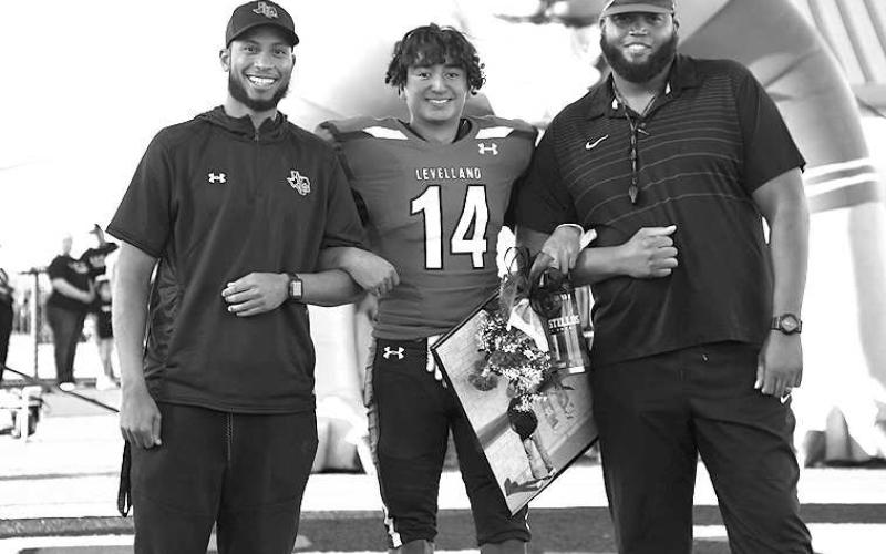 SENIOR LOBO- Levelland seniors were recognized last Friday during the Lobos home win game against Borger. Lobo Mimo Bustillos was escorted by Levelland coaches Lyle Leong and Marlon Winn. (Staff Photo by Dom Puente)