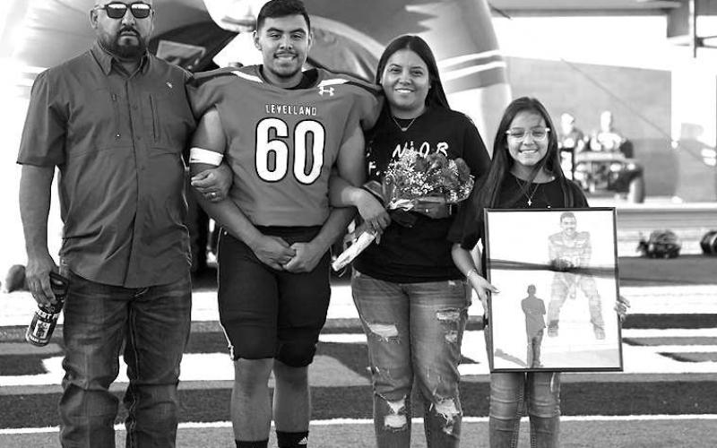 SENIOR LOBO- Levelland seniors were recognized last Friday during the Lobos home win game against Borger. Lobo Robert Pina was escorted by his parents Roberto and Brandy Pina. (Staff Photo by Dom Puente)