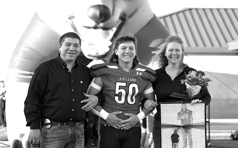 SENIORLOBO- Levelland seniors were recognized last Friday during the Lobos home win game against Borger. Lobo Ethan Campos was escorted by his parents AJ and Sarah Campos. (Staff Photo by Dom Puente)