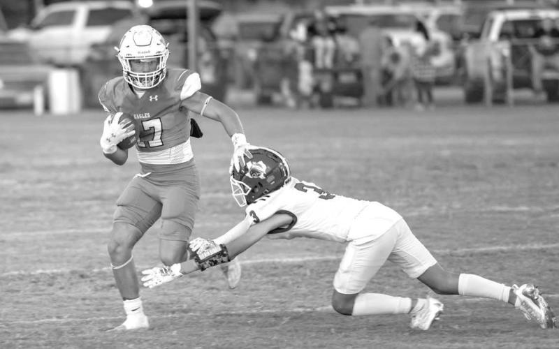 STIFF ARM - Ropes athlete Hayden Torres stiff armed a Smyer player on the way to the endzone. Smyer Bobcat Ryan Gutierrez tried making the tackle on Hayden during both teams district opener. (Photo courtesy of Donovan Martin)