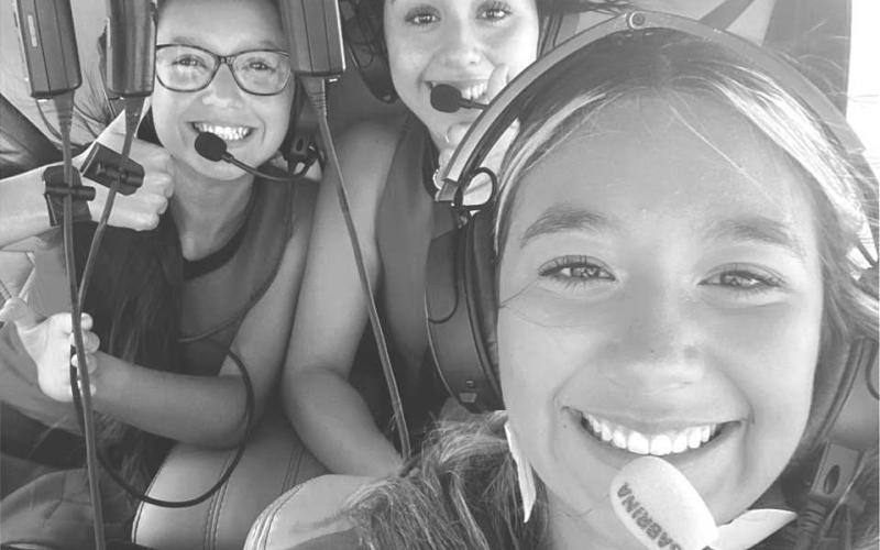 GAME BALL- Levelland High School Cheer Coach Northcutt and LHS Cheer leaders arranged for the game ball to be delivered by helicopter this past Friday. Shown in no particular order Kameala Baeza, Taylyn Ledesma and Alex Pena riding in helicopter with Derek Dunn (not pictured) to make that game ball delivery to the Levelland football stadium.(Photo submitted by Cristal Isaacks)