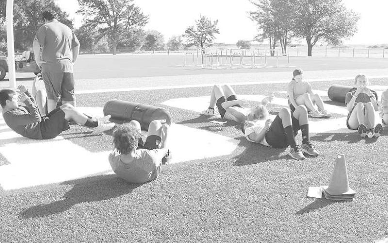 CURLS - Sundown athletes did sit-ups while at the summer workouts to make themselves better. (Staff Photo by Aalijah Soliz)