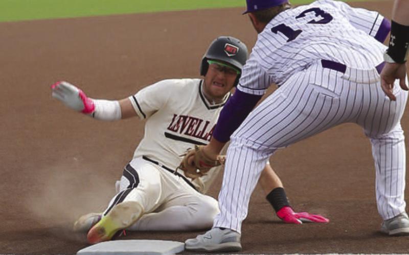 MAXIMUM EFFORT - Levelland Lobo Rance Massey slid into third base during the team’s first game of the Greenwood Tournament this past Thursday morning. (Staff photo by Aalijah Soliz)