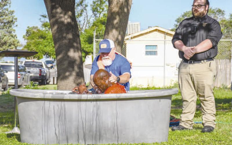 HCSO INMATE BAPTIZING - Twenty-one inmates at the Hockley County Jail were baptized Friday morning courtesy of Minister Dewey Gragson. Pictured is Gragson performing a baptism alongside HCSO Jailer McClain. Gragson has been visiting the jail every Monday to hold Celebrate Recovery lessons for interested inmates. (Staff photo by Hannah Woodrum)