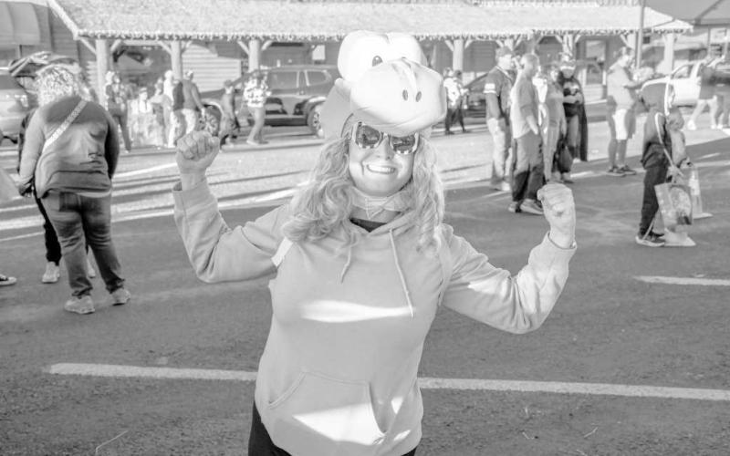 YOSHI – Danielle posed in her Yoshi costume before going to take photos with other Mario characters during downtown Levelland’s Trunk or Treat event on Thursday. (Staff photo by Evin Thomas)