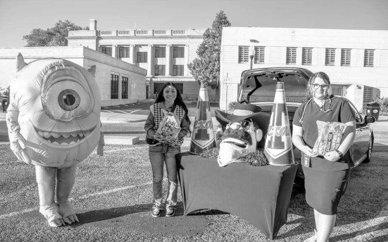 SPC CANDY – Maci and Rosie handed out candy to trunk or treaters from a South Plains College organization booth during Thursday’s Halloween event in Levelland. (Staff photo by Evin Thomas)