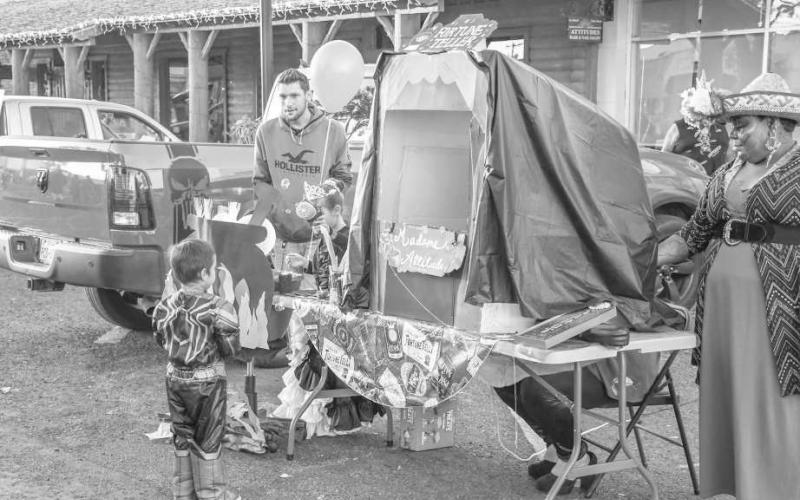 MADAMEATTITUDE – A Madame Attitude palm reading and crystal ball booth was set up along Houston Street to interact with attendees of Thursday’s Trunk or Treat event. (Staff photo by Evin Thomas)