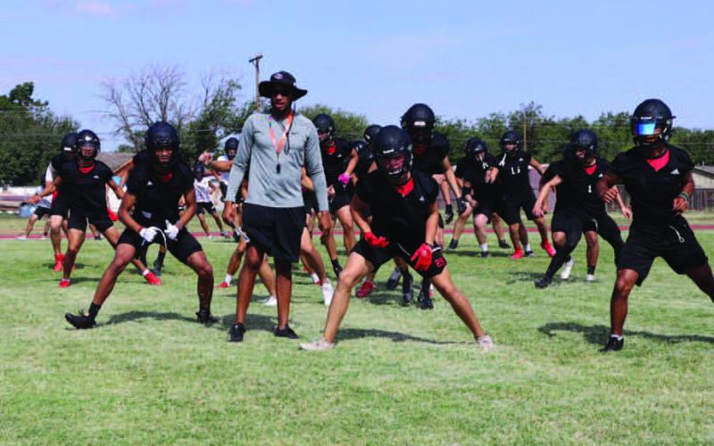 WARMUPS - The Levelland Lobo Football Team began their morning warm-up routine with Athletic Director and Head Coach Lyle Leong watching his players stretch. (Staff photo by Aalijah Soliz)