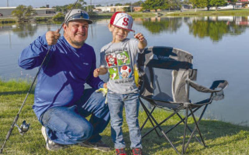 GOOD CATCH - Pictured are Louis and Jacob Martinez with a catfish they caught at Lobo Lake on Saturday at Casting With Cops. (Staff photo by Ada Niederhauser)