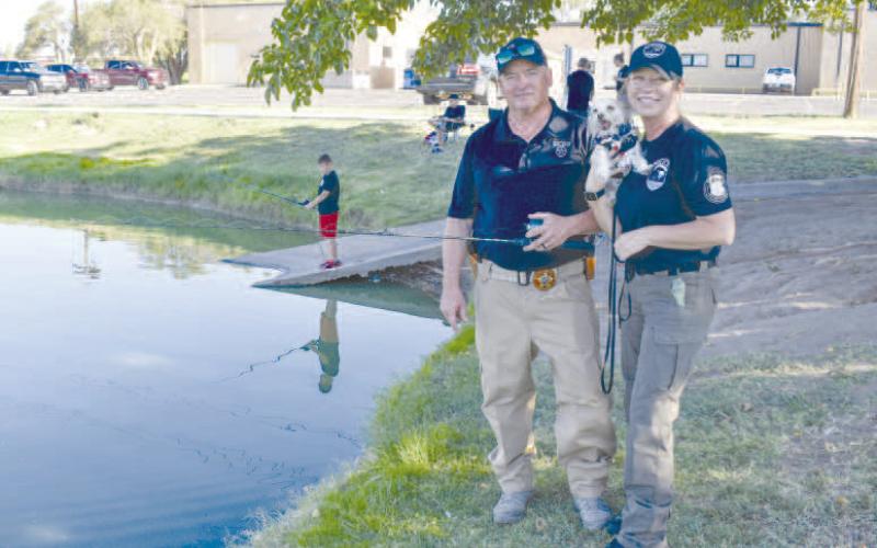 CASTING WITH COPS - Pictured are HCSO’s Deputy Brown and LPD’s Detective Brown with their dog Nash who were having fun at the Casting With Cops event at Lobo Lake on Saturday. (Staff photo by Ada Niederhauser)