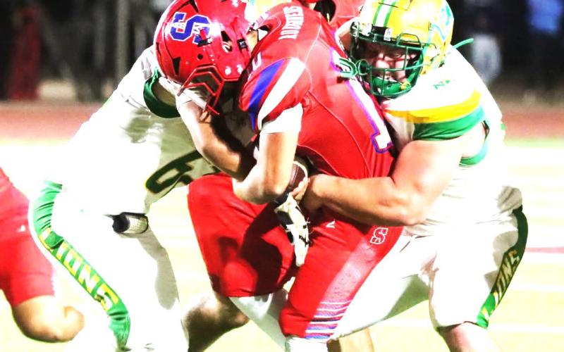 Sundown Roughneck ball carrier battles defense.