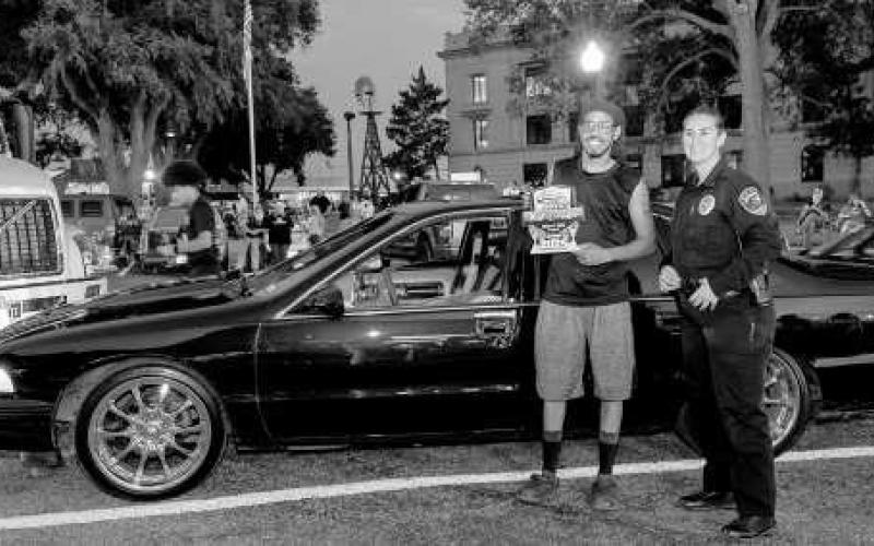 CRUISE WINNER - Pictured is Shad Whitfield with LPD Chief Erica O’Bryon after receiving an award during the Thunder on the Plains Cruise. (Photo courtesy of J. Conrad Photography)