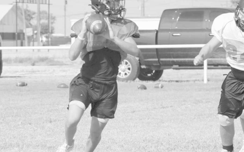 IMPROVISE - Whitharral athlete Brolin Kennedy rolled out for the pass during team practices during twoa- days training. (Staff photo by Aalijah Soliz)