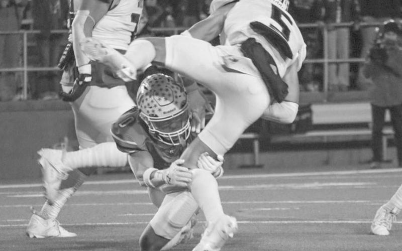 GET OVER HERE - Ropes Eagle Branson Simental brought down the Gruver Greyhound ballcarrier last Friday night in Canyon during the team’s last game of the season. (Staff photo by Aalijah Soliz)